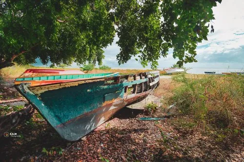 Old damaged pirogue on the beach