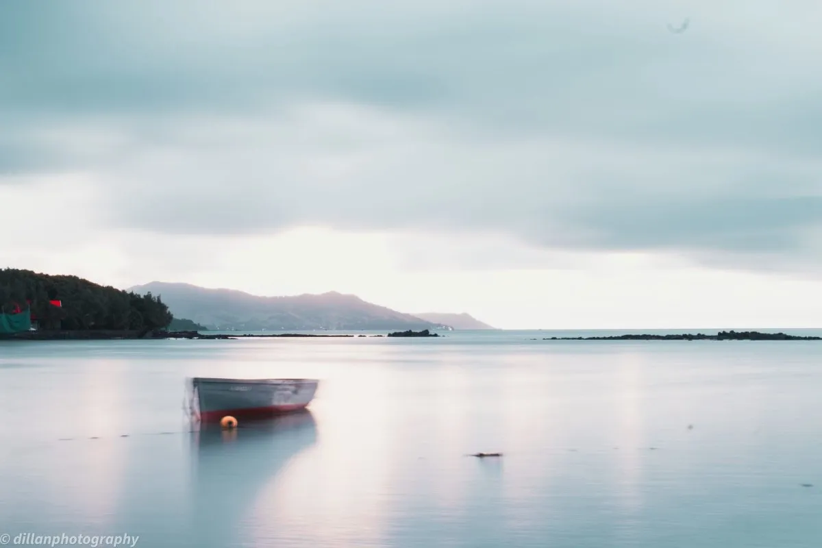 Long exposure photo of a boat and calm sea in Mahebourg lagoon, Mauritius