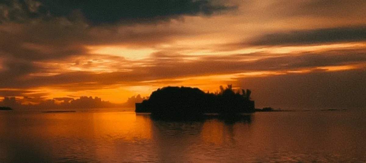 Sunrise silhouette of Mouchoire Rouge Island near Mahebourg in Mauritius