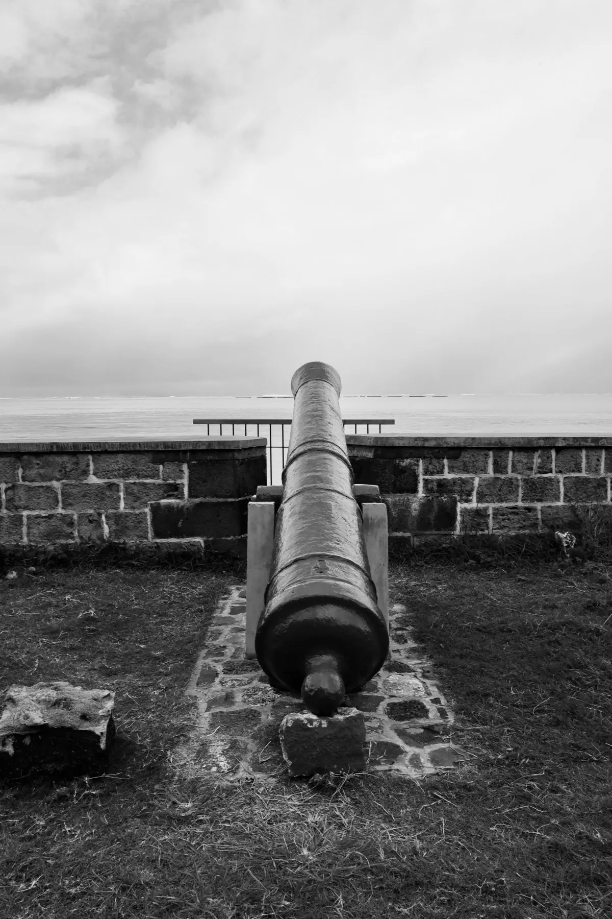Black and white photo of an old cannon at Pointe Canon overlooking the sea in Mahebourg, Mauritius