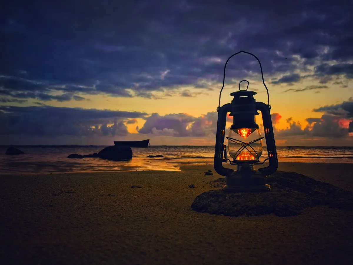 Old oil lamp on a Mauritius beach just before sunrise in soft early morning light