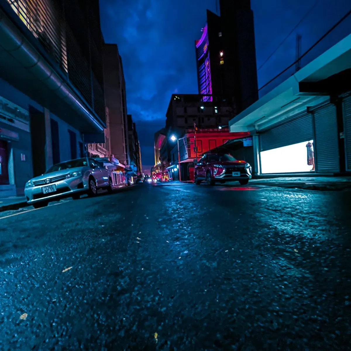 Night street scene with cars and buildings in a city of Mauritius