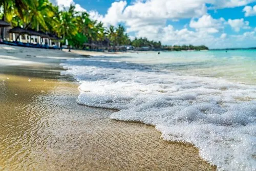Belle Mare beach with calm waves reaching the coast