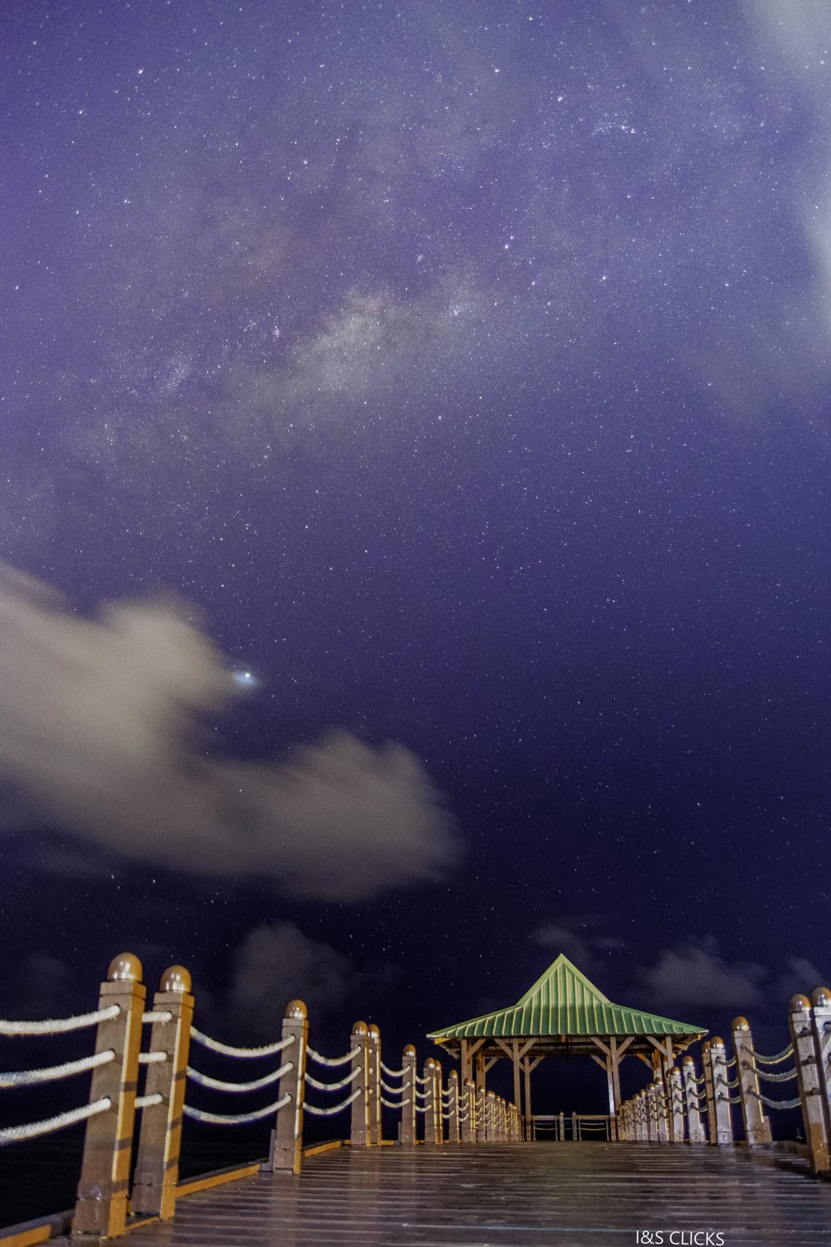 Milkyway shining over wooden jetty in Mahebourg, Mauritius under a starry night sky