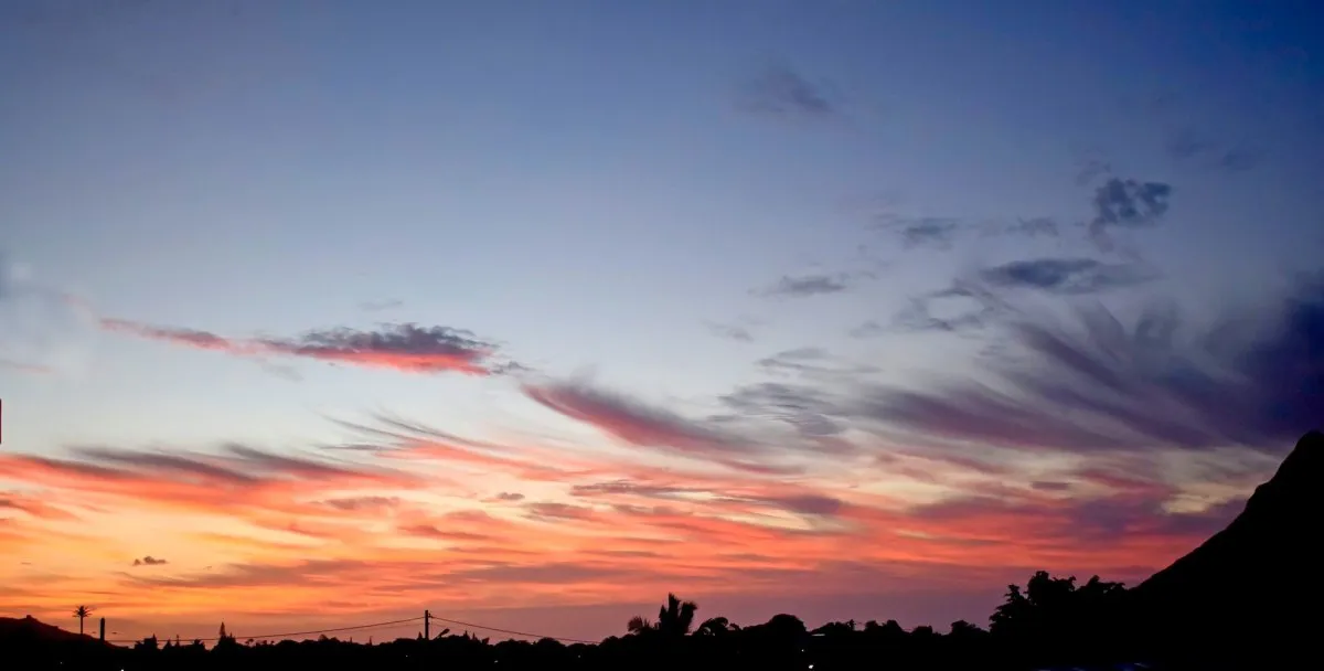 Orange cirrus clouds blowing across the sky at sunset in Mauritius