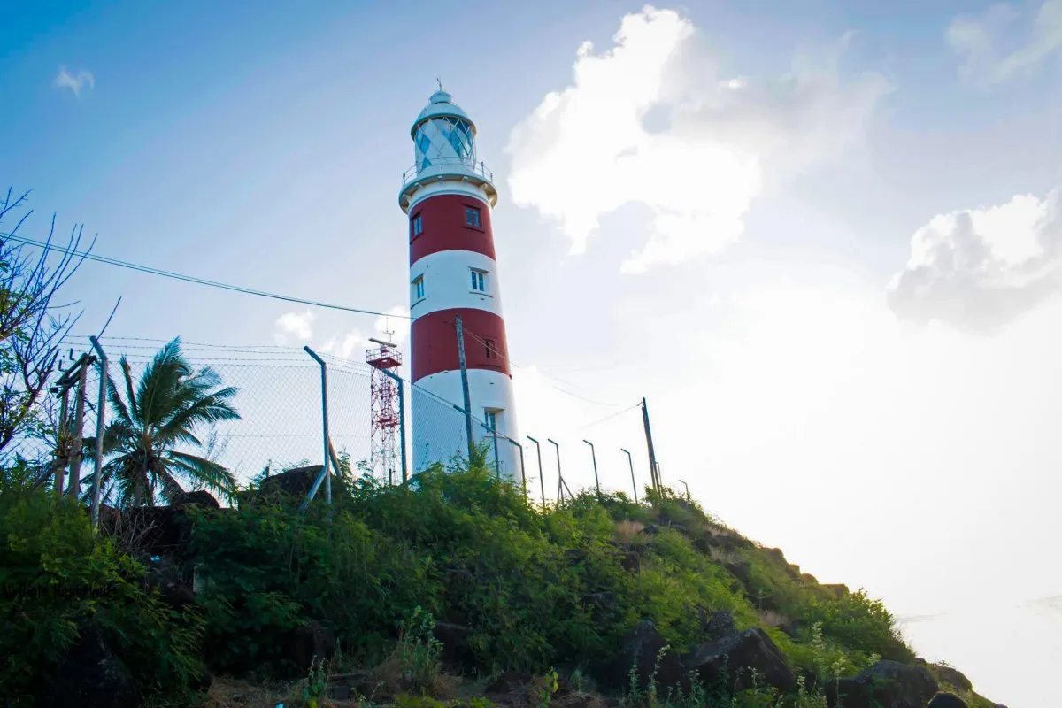 Closeup of the red and white Albion Lighthouse near cliffs in Mauritius