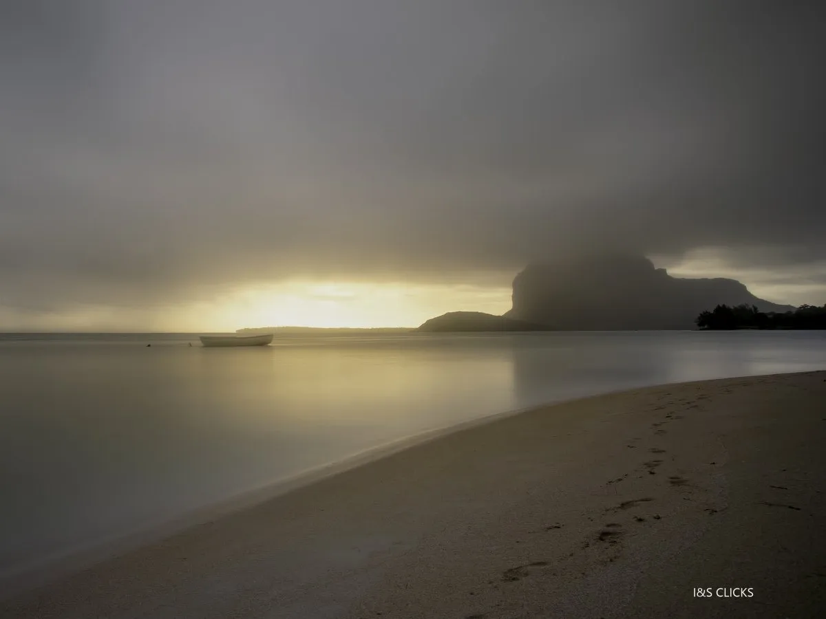 Misty haze over La Prairie beach with Le Morne mountain at sunset in Mauritius