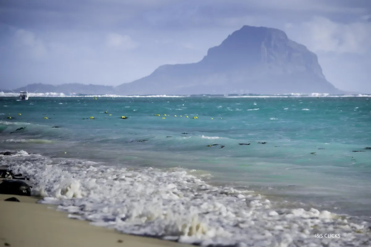 Turquoise rough sea waves crashing at Flic en Flac beach in Mauritius