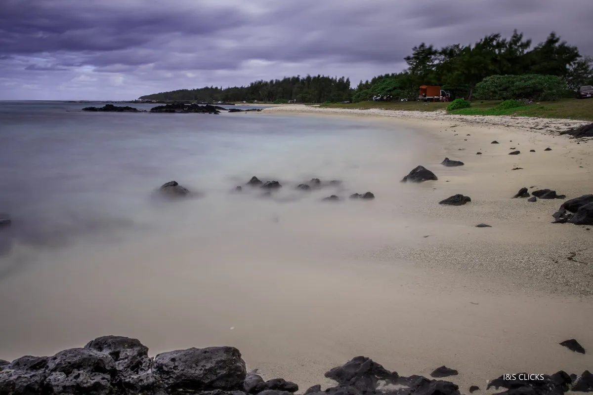 Long exposure of Palmar Beach with smooth sea and clouds on Mauritius's east coast