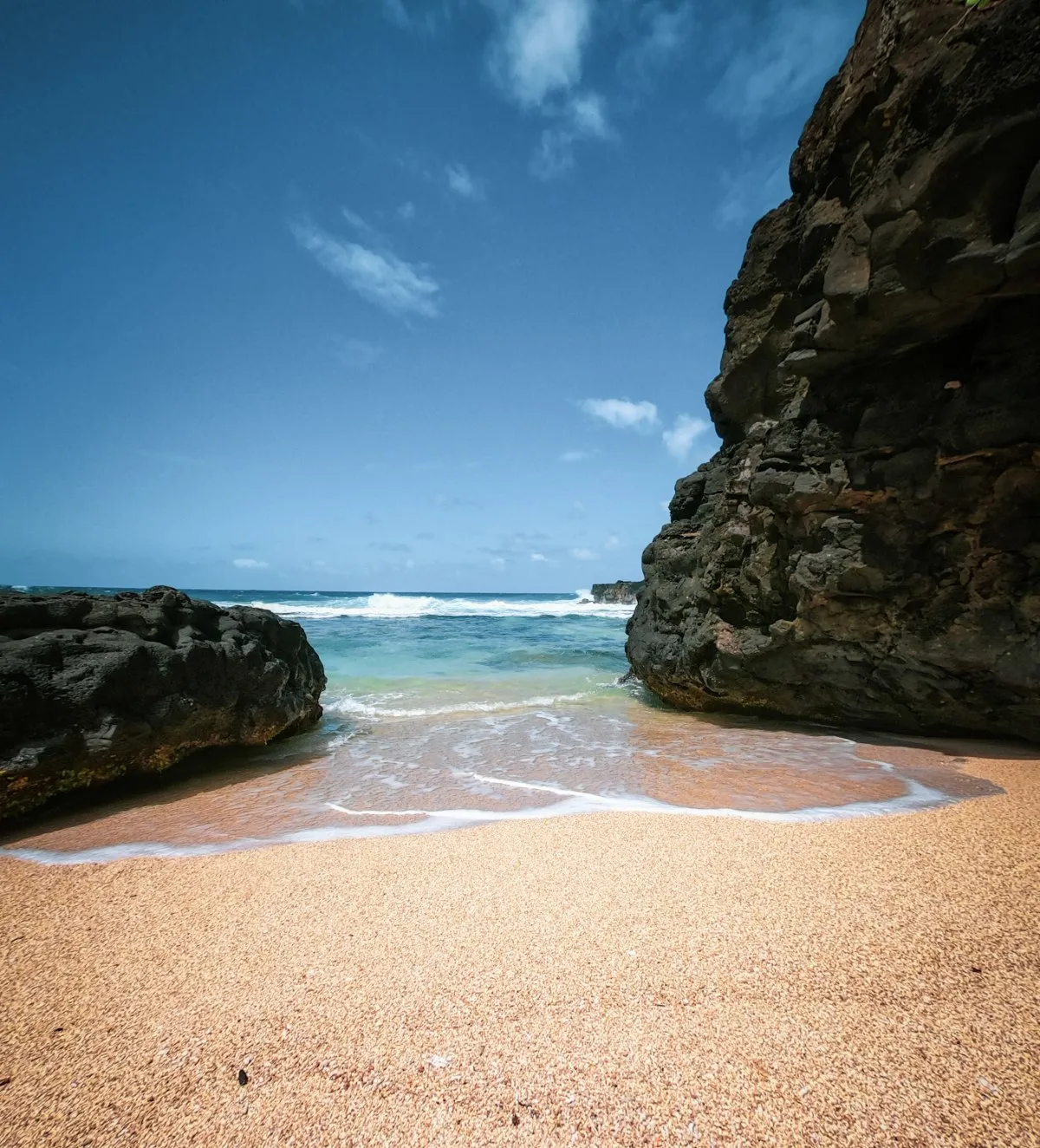 Lagoon view between large volcanic rocks on a beach in Mauritius