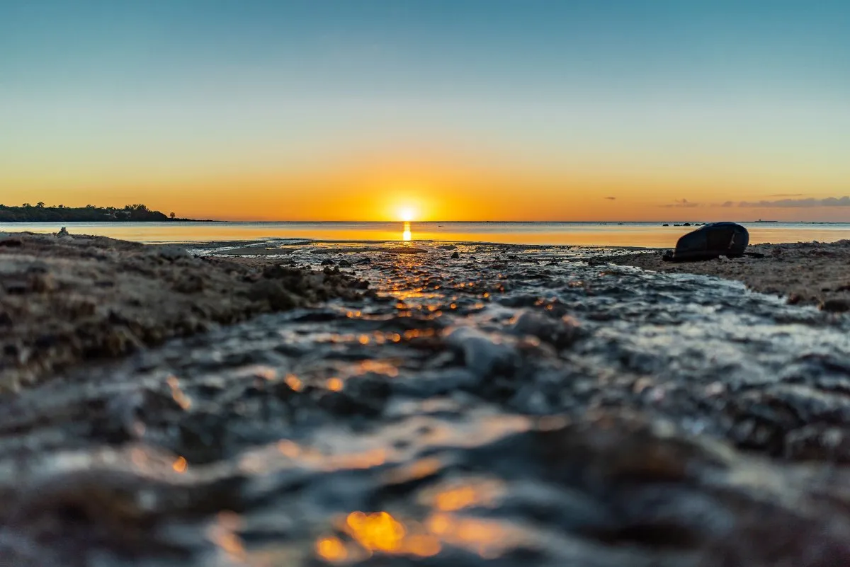 Creek waterway flowing to the sea with a sunset in Albion, Mauritius