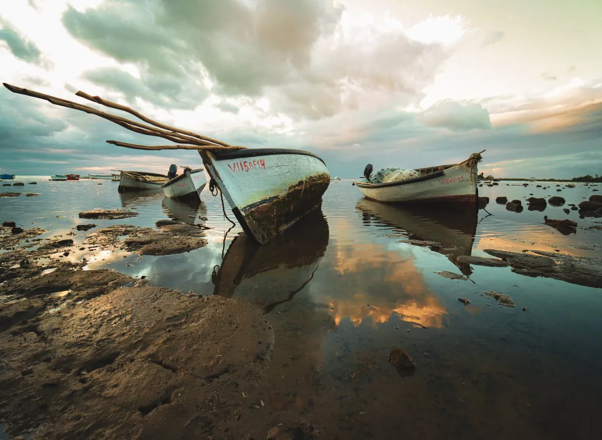Two boats berthed on a muddy beach at Case Noyale in Mauritius