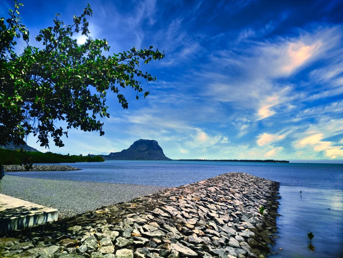 Rocky man-made jetty with Le Morne mountain in the background in Mauritius