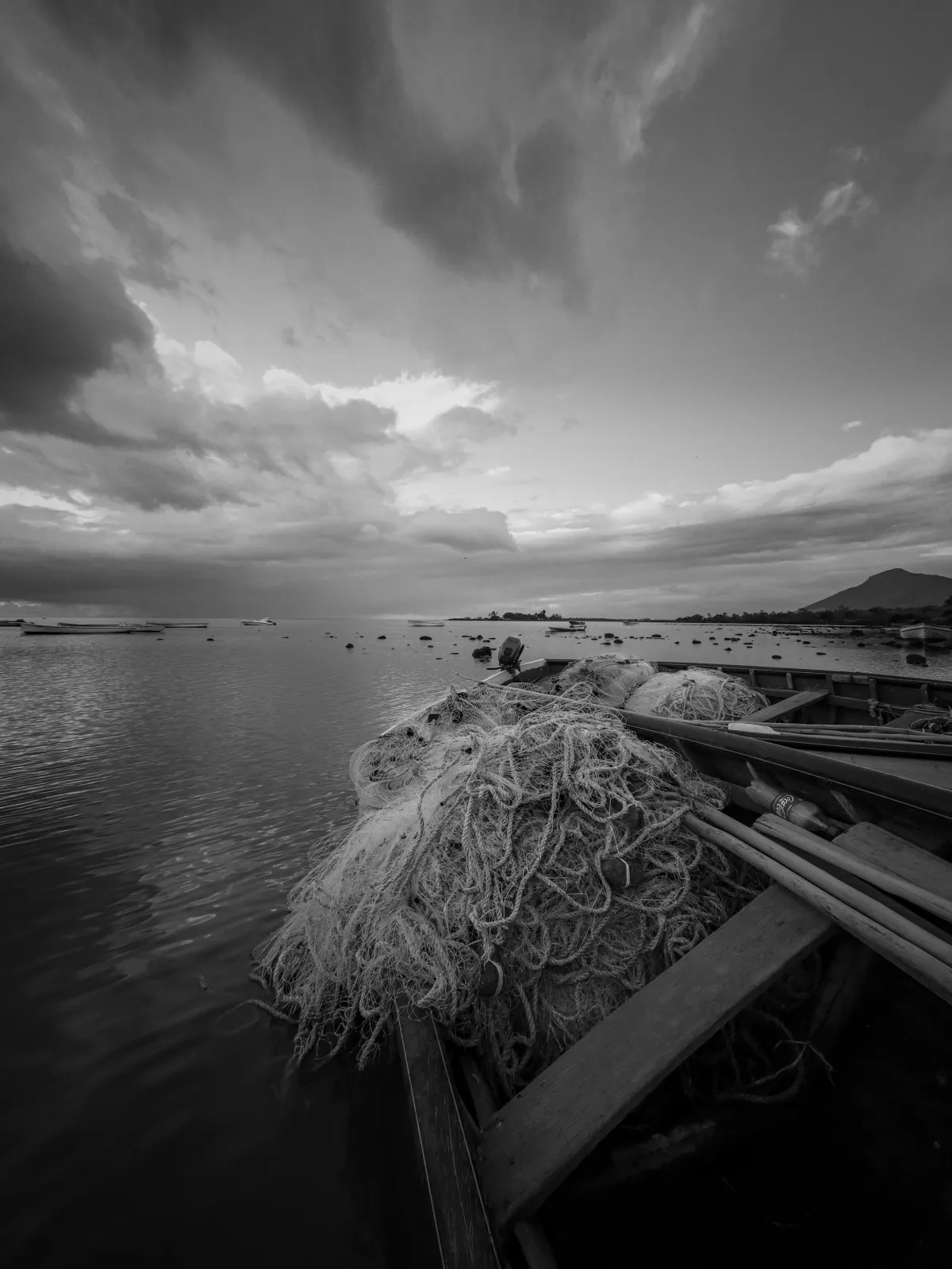 Black and white image of a fishing boat on the shore in Mahebourg, Mauritius
