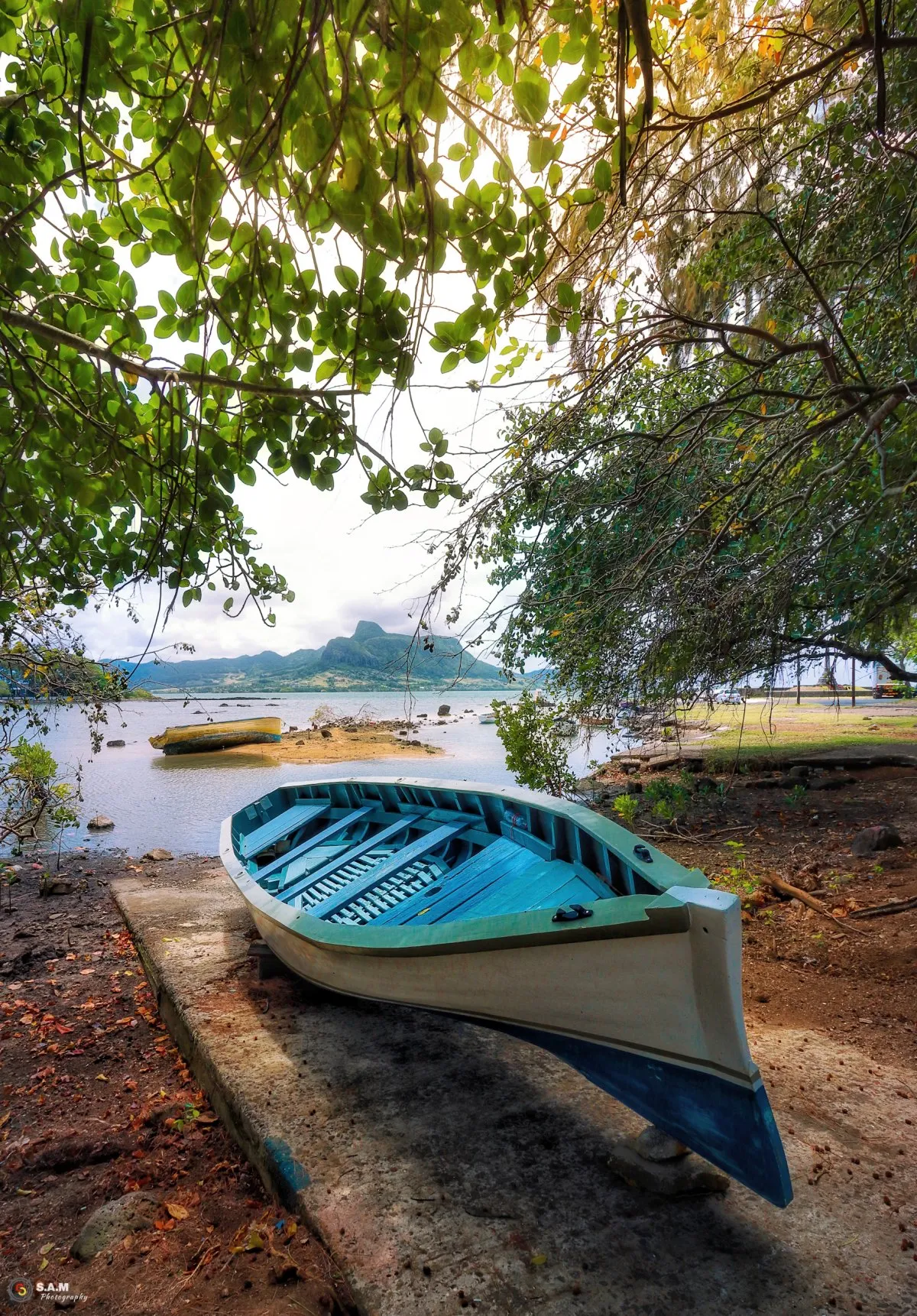 Fishing pirogue on the coast of Mahebourg with Lion Mountain in Mauritius