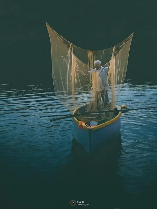 Fisherman setting nets early morning in Mahebourg