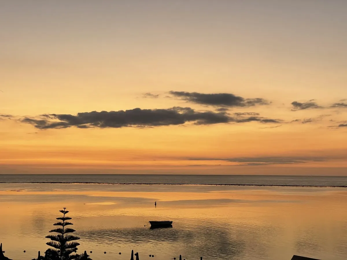 Orange sky during golden hour after sunset at Flic en Flac beach in Mauritius