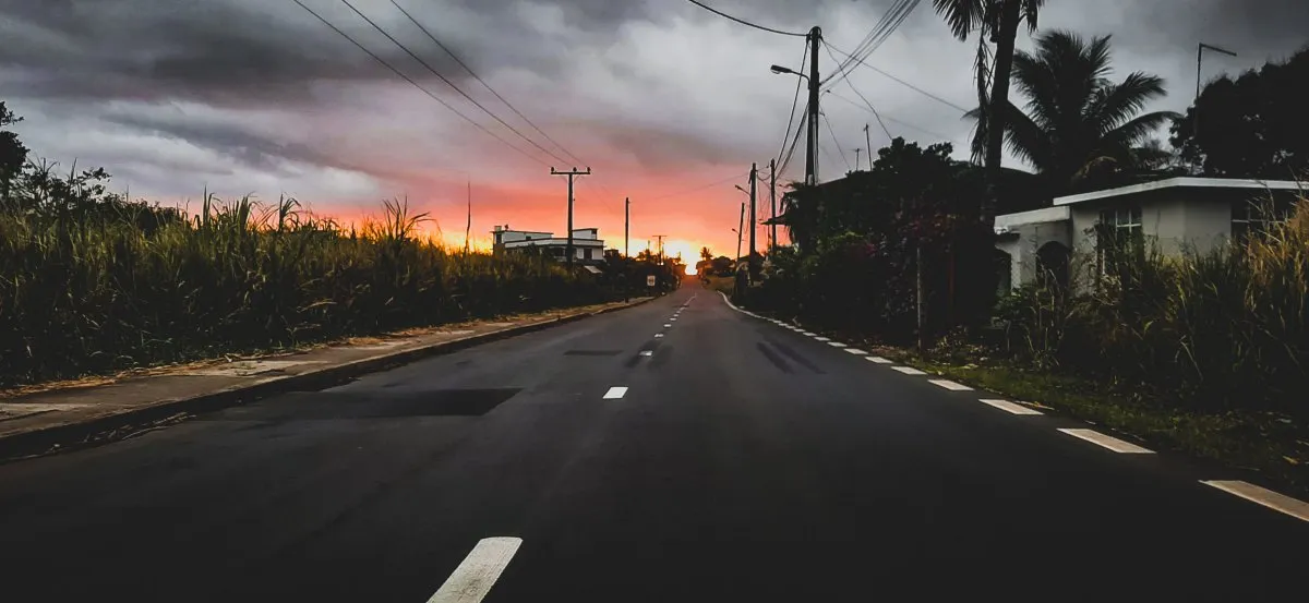 Sunset over a village road in Mauritius with warm vibrant colors