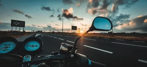 Sunset view from motorcycle on motorway