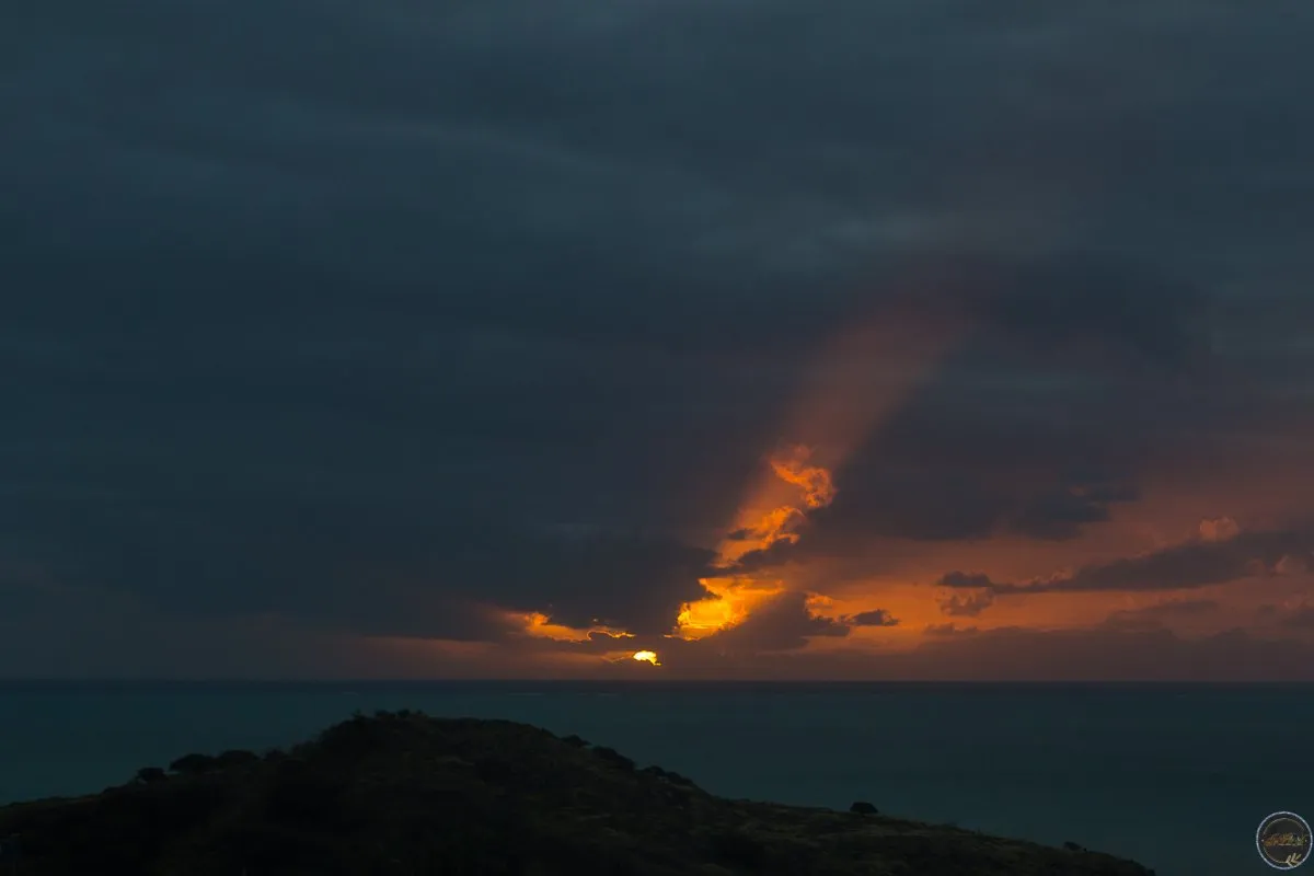 Sunset rays over Ile aux Cocos and Ile aux Sable islands in Rodrigues, Mauritius with cloudy sky