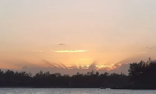 Sunset behind clouds at Blue Bay Beach